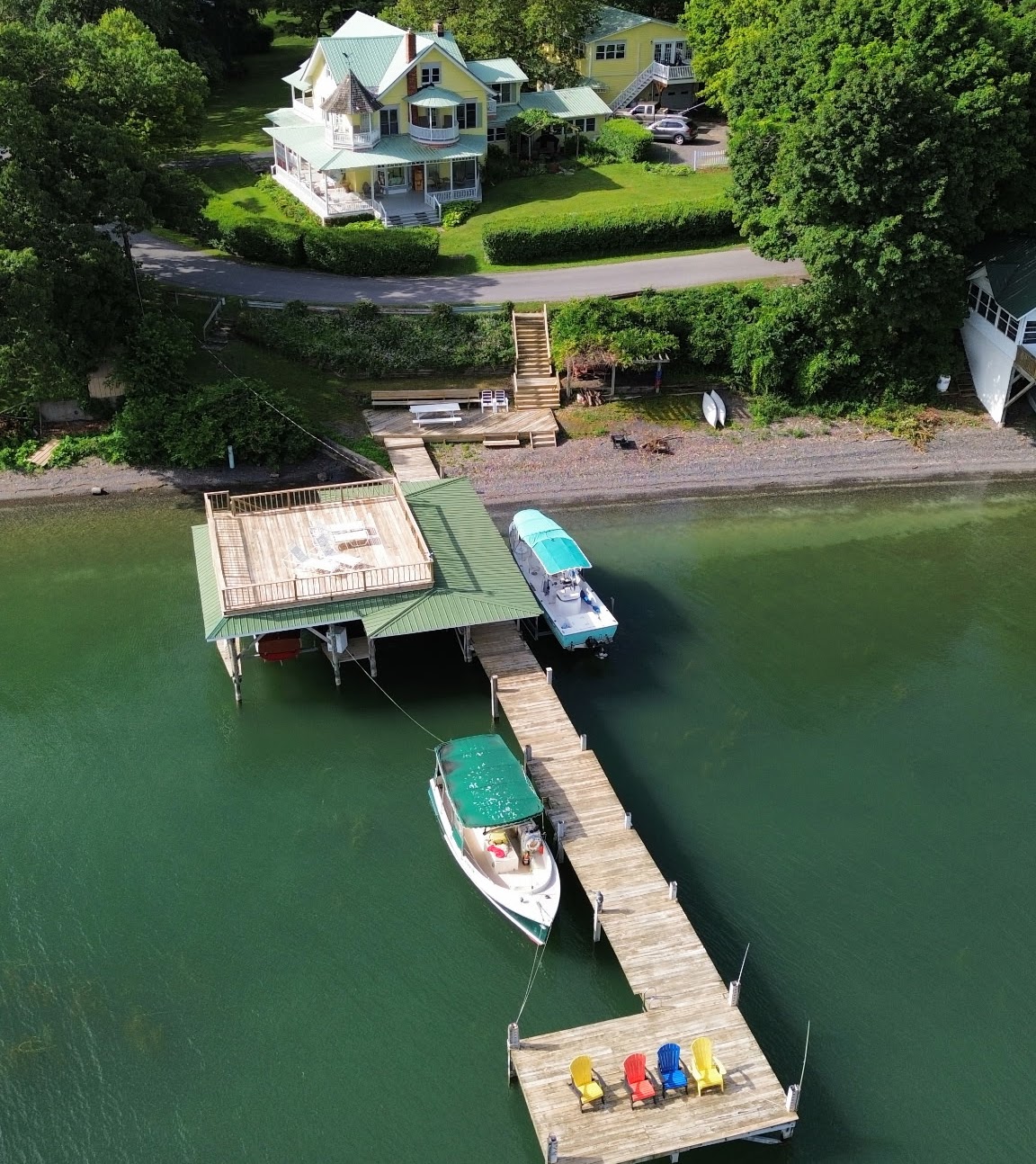 The Silver Strand, a yellow Victorian home on Cayuga Lake with a private dock